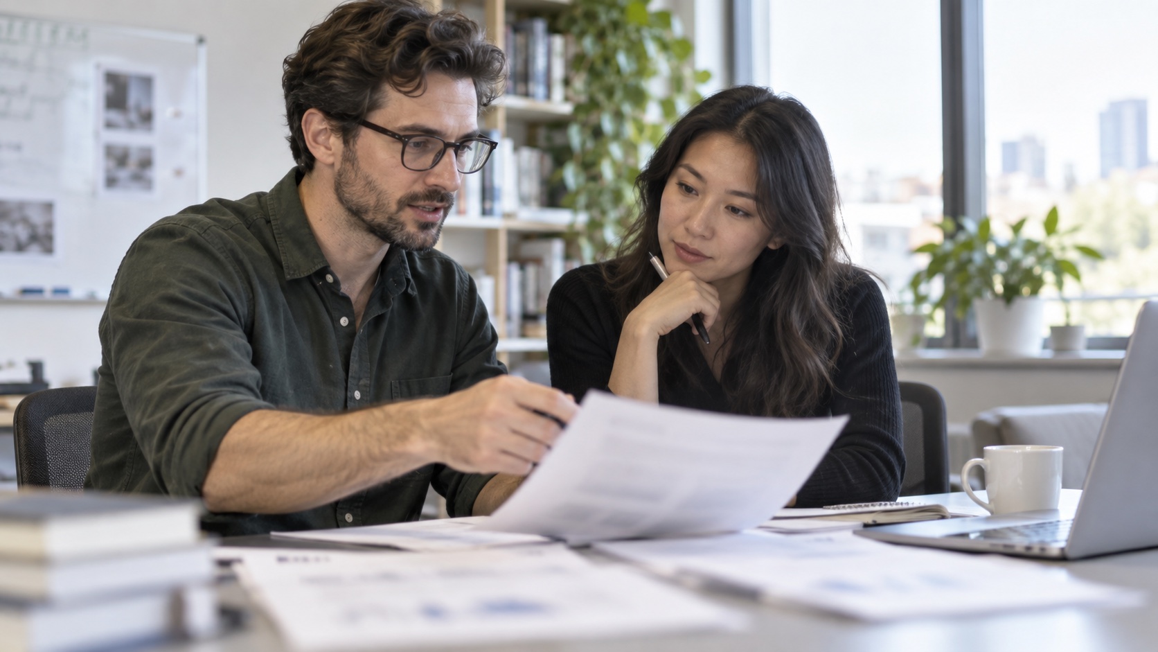 Researchers review softly blurred trial pages at a desk.